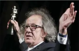  ?? THE ASSOCIATED PRESS ?? Geoffrey Rush poses with his ‘Berlinale Camera Award’ wich he received prior to the screening of the film ‘Final Portrait’ at the 2017 Berlinale Film Festival in Berlin.