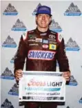  ?? —AFP ?? SPARTA: Kyle Busch, driver of the #18 Snickers Toyota, poses for a photo after winning the pole award during qualifying for the Monster Energy NASCAR Cup Series Quaker State 400 presented by Advance Auto Parts at Kentucky Speedway on Friday in Sparta, Kentucky.