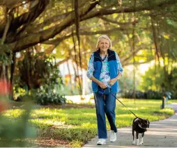  ??  ?? Resident Louise Redmond walks her dog after recovering from a leg injury at Shell Point’s medical facilities.