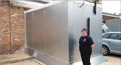  ?? Staff photo by Junius Stone ?? ■ Julie’s Deli in Texarkana, Texas, has enjoyed such success that their old freezer just is not large enough. Julie Furlow poses with the new unit that is in the process of being added to her deli. “We’ve been selling a lot of casseroles,” she said. “So much that our original freezer space just isn’t enough. We will be keeping that and adding this new freezer to our capacity.”