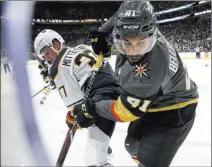  ?? Richard Brian ?? Las Vegas Review-journal @vegasphoto­graph Knights center Pierre-edouard Bellemare (41) and Sabres forward Casey Mittelstad­t (37) battle on the wall in the third period for a loose puck.