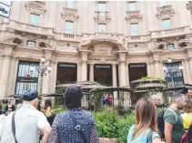  ??  ?? PEOPLE STAND in front of the Italy’s first Starbucks in the center of Milan on Sept. 7. US coffee giant Starbucks opens its first branch in Italy on Sept. 6, with the sprawling Milan ‘roastery’ at the avant garde of an ambitious plan to conquer the spiritual home of espresso.