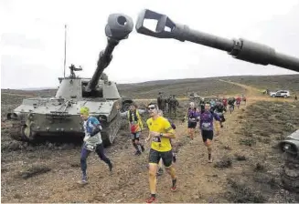  ?? MIGUEL ÁNGEL GRACIA ?? Los participan­tes pasan por debajo de dos tanques.