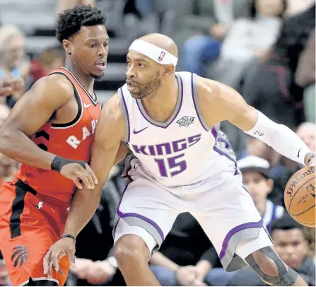  ?? FRANK GUNN/THE CANADIAN PRESS ?? Sacramento Kings’ guard Vince Carter looks to move around Toronto Raptors’ guard Kyle Lowry during first half NBA basketball action in Toronto, on Sunday.