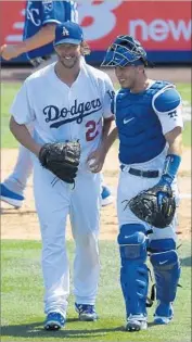  ?? Mark J. Terrill Associated Press ?? CLAYTON KERSHAW, left, who struck out 13, and Austin Barnes, who homered, savor Dodgers’ win.