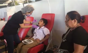  ?? MERLINDA PEDROSA ?? A Healthcare­profession­al attends to a patient during the medical mission at the Ceres North Terminal in Barangay Bata, Bacolod City yesterday.