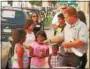  ?? DIGITAL FIRST MEDIA FILE PHOTO ?? A member of the Law Enforcemen­t Explorers hands a police badge sticker to a youngster during Water Ice With a Cop in the 600 block of Green Street, Norristown, Thursday, Aug. 4, 2016.