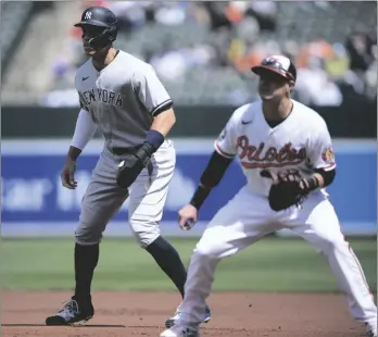  ?? AP PHOTO/NICK WASS ?? New York Yankees’ Aaron Judge (left) takes a lead from first next to Baltimore Orioles first baseman Ryan Mountcastl­e (6) during the first inning of a baseball game, on Sunday in Baltimore.