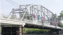  ?? LYLE ASPINALL ?? The 12 St. S.E. bridge between the Calgary Zoo and Inglewood was to stay open for pedestrian­s during constructi­on of its replacemen­t but the deteriorat­ing state of the bridge has made that impossible.