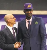  ??  ?? The NBA might be using more small-ball lineups, but the top two selections in Thursday’s draft were big men: 7-foot-1 DeAndre Ayton of Arizona (with Commission­er Adam Silver), left, who went to the Suns, and 6-foot-11 Marvin Bagley III of Duke, who was...