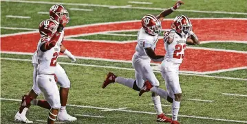  ?? VINCENT CARCHIETTA/ USA TODAY SPORTS ?? Indiana defensive backs Jamar Johnson ( 22), Devon Matthews ( 1) and Jaylin Williams ( 23) celebrate a stop vs. Rutgers. Improved secondary play has been a key part of Indiana’s success.