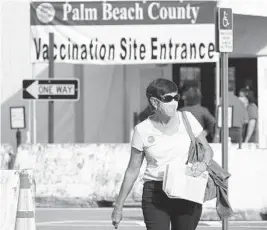  ?? JOE CAVARETTA/SOUTH FLORIDA SUN SENTINEL ?? A client leaves the Palm Beach County Health Department COVID-19 vaccinatio­n site at the South Florida Fairground­s on Feb. 10. The newly opened site is walk-up and by appointmen­t only.