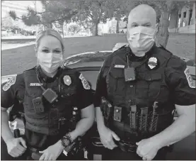  ?? Contribute­d ?? Floyd County police officers Brittney O’bryant (left) and Todd Jackson show off their Breast Cancer Awareness badges for the month of October.