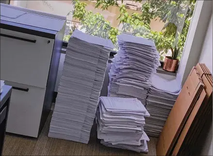  ?? TONY CASTANEDA / HARRIS COUNTY PUBLIC HEALTH VIA THE NEW YORK TIMES ?? The fax machine at the Harris County Public Health department in Houston recently became overwhelme­d when one laboratory sent a large batch of test results, spraying hundreds of pages all over the floor.