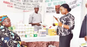  ??  ?? Dr. Ladi Shambo (left) attends to customers at her stand at the Daily Trust agric conference and exhibition in Abuja yesterday.