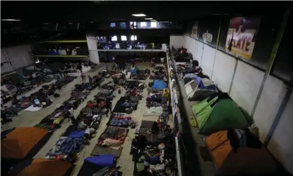  ??  ?? Migrants begin their day inside a former concert venue serving as a shelter, in Tijuana, Mexico. Photograph: Rebecca Blackwell/AP