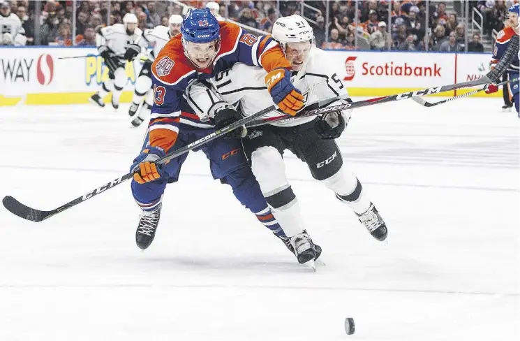  ?? JASON FRANSON /THE CANADIAN PRESS ?? Oilers defenceman Matthew Benning races Austin Wagner of the L.A. Kings for the puck Thursday night at Rogers Place. The Oilers won 3-2.