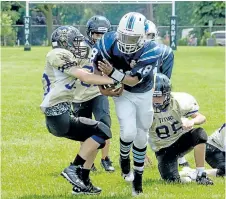  ?? ED TELENKO/SPECIAL TO POSTMEDIA NEWS ?? Niagara Titans defender Elijah Lovegrove, left, tries to strip the ball from Niagara Falls Argonauts back Marshall McCray in bantam football action Sunday at Westlane Secondary School in Niagara Falls.