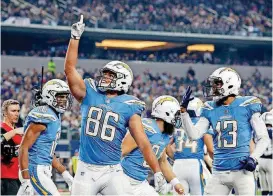  ?? [AP PHOTO] ?? Los Angeles Chargers’ Hunter Henry (86) celebrates his touchdown catch with Tyrell Williams (16) and Keenan Allen (13) in the second half of Thursday’s game against the Dallas Cowboys in Arlington, Texas.