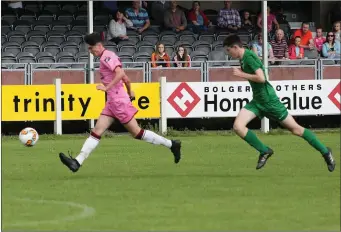  ??  ?? Wexford’s hat-trick hero Brody Murphy is chased by Sean Cummins of Cork City.