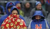  ?? KATHY WILLIAMS — ASSOCIATED PRESS ?? Mets fans bundle up against 40 degree temperatur­es during a game April 15 in New York vs. the Brewers.