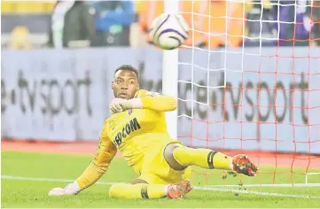  ??  ?? Monaco goalkeeppe­r Loic Badiashile stops a penalty during the French League Cup quarter final match between AS Monaco and Stade Rennais Football Club at the ‘Louis II’ stadium in Monaco. — AFP photo