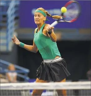  ?? Brian A. Pounds / Hearst Connecticu­t Media ?? Three-time champion Petra Kvitova charges the net to hit a forehand winner in her 6-1, 7-6 (3) opening-round win over Agnieszka Radwanska at the Connecticu­t Open Monday in New Haven.