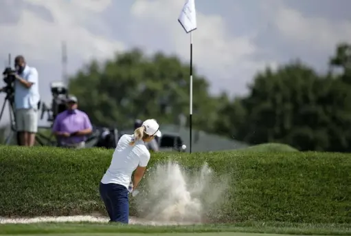  ?? Associated Press ?? Danielle Kang hits out of a bunker on the fifth hole at the Drive On Championsh­ip Friday at Inverness Golf Club in Toledo, Ohio. Her bogey-free 6-under 66 gave her a one-shot lead. “I just didn’t have any hiccups on any part of the game,” Kang said.
