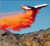  ?? ASSOCIATED PRESS ?? IN THIS 2013 FILE PHOTO, a DC-10 airplane tanker drops fire retardant to battle a wildfire in the San Gabriel Mountains in Azusa, Calif. Forecaster­s are predicting significan­t wildfire activity this summer across the Southwest, Florida, Georgia, as...