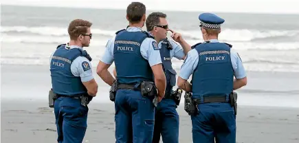  ??  ?? Police officers yesterday on Scarboroug­h Beach. They were part of emergency services searching for a teenage boy reported missing.