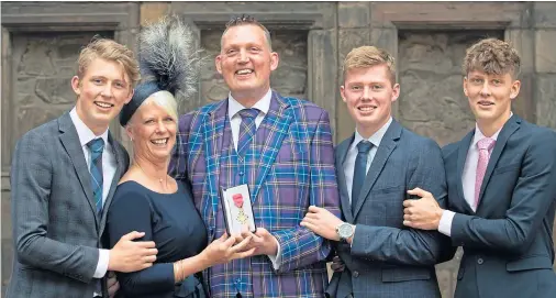  ??  ?? PROUD: Former rugby internatio­nal and motor neurone disease campaigner Doddie Weir, with wife Kathy and sons Hamish, Ben and Angus