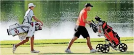  ?? [PHOTO BY STEVE SISNEY, THE OKLAHOMAN] ?? Oklahoma’s Garett Reband, left, and Oklahoma State’s Zach Bauchou were grouped together in the first two rounds of the NCAA men’s golf championsh­ips. Bedlam could reach another level on Tuesday if the two teams advance to the semifinal round of match...