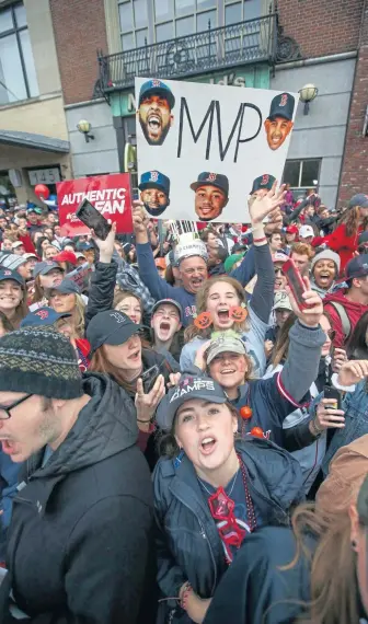  ?? NICOLAUS CZARNECKI / BOSTON HERALD ?? DAMAGE DONE: Fans line up to cheer on the Red Sox at their victory parade yesterday.