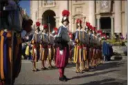  ?? ANDREW MEDICHINI — THE ASSOCIATED PRESS ?? Vatican Swiss Guards stand at attention in front of St. Peter’s Basilica at the Vatican prior to the arrival of Pope Francis to celebrate an Easter mass, Sunday.