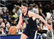  ?? Nick Wass/Associated Press ?? UConn forward Alex Karaban (11) dribbles against Georgetown in Washington on Saturday.