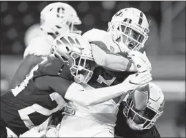  ?? Chris Pietsch Associated Press ?? STANFORD’S Austin Jones, center, fights for tough yards against Oregon during the first quarter in Eugene, Ore. Jones rushed for 100 yards and two touchdowns.