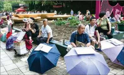  ?? GAO ERQIANG / CHINA DAILY ?? People’s Park in downtown Shanghai has become the setting for a matchmakin­g market as parents place umbrellas, each carrying sheets of paper containing informatio­n about their unmarried children. On a recent Saturday afternoon, more than 500...
