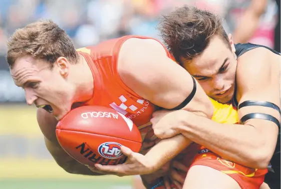 ??  ?? Brandon Matera is tackled by Port Adelaide’s Karl Amon in the Suns’ Shanghai disaster. Picture: AAP IMAGE