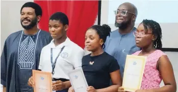  ?? ?? Caption: Managing Director of Toyota Nigeria Limited (TNL), Mr. Kunle Ade-Ojo; and Head of Marketing at TNL, Mr. Bayo Olawoyin, with national winners of the 17th Toyota Dream Car Art Contest in the 8-11-year category, Oluwalani Tamara Oshinubi, 1st position; Sochikaima Nwizu, 2nd; and Vivian Ugooma Emeh, 3rd, receiving the award certificat­es along with other gift items at the TN L head office in Lek ki, Lag os… recently