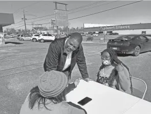  ?? ANDREW DEMILLO/AP ?? Democratic gubernator­ial candidate Chris Jones speaks to campaign volunteers outside his campaign office in Pine Bluff, Ark., on Feb. 19.