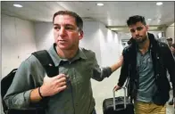  ?? RICARDO MORAES / REUTERS ?? US journalist Glenn Greenwald (left) walks with his Brazilian partner David Miranda in Rio de Janeiro’s Internatio­nal Airport on Monday.