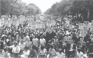  ?? AP FILE PHOTO ?? Fifty years ago to the day, thousands march down Constituti­on Avenue in Washington. Organizers of the 1963 march tightly controlled the messages they wanted to get across and what types of signs people held.