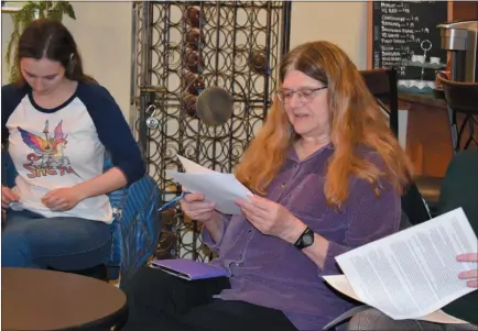  ?? PHOTO BY LAURA CATALANO ?? Janet Fitzpatric­k peruses a list of future selections for the non-fiction book club. Fitzpatric­k is a member of seven book clubs.