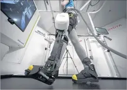  ?? EUGENE HOSHIKO/AP ?? Toyota’s Welwalk WW-1000 robotic leg brace is designed to cut rehabilita­tion time.