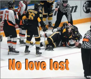  ?? NEWS PHOTO RYAN MCCRACKEN ?? Brandon Wheat Kings defenceman Kade Jensen wrestles Medicine Hat Tigers Zach Fischer to the ice during Game 2 of the WHL's Eastern Conference quarter-finals, Saturday at the Canalta Centre.