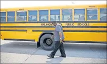  ?? [SARAH PHIPPS/ THE OKLAHOMAN] ?? Bus driver Charles Edwards demonstrat­es his safety check during a press conference at the Operations Center/Bus Barn for Oklahoma City Public Schools on Aug. 6.