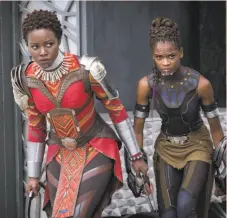  ?? Matt Kennedy / Marvel Studios-Walt Disney ?? Lupita Nyong'o (left) and Letitia Wright in “Black Panther,” a film with female scientists, warriors.