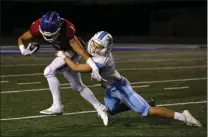  ?? PHOTO BY TRACEY ROMAN ?? Los Alamitos receiver Keanu Norman tries to break free from Corona del Mar's Jack Elliott during a game in October 2018in Cerritos.