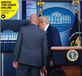  ??  ?? WATCH THE VIDEO ONLINE standard.co.uk/ escorted
Shooting fears: Donald Trump leaves briefing with a member of the secret service