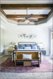  ?? GRACE LAIRD PHOTOGRAPH­Y/MOORE HOUSE INTERIORS VIA AP ?? This 2017 photo shows a master bedroom designed by interior designer Ashely Moore. Moore layered a patterned rug over neutral wall-to-wall carpeting to add an extra layer of warmth and additional color to this master bedroom.